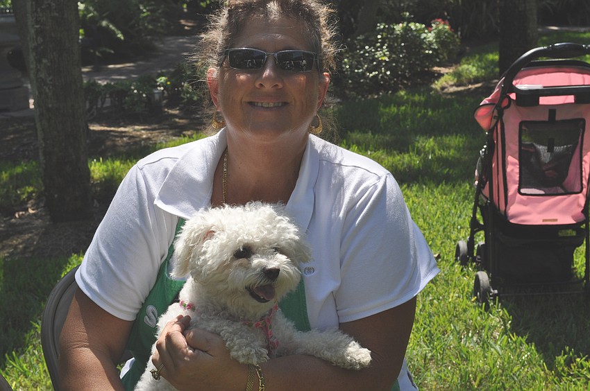 Christine Ortiz and her dog snowy. Ortiz wanted her dog blessed because, 