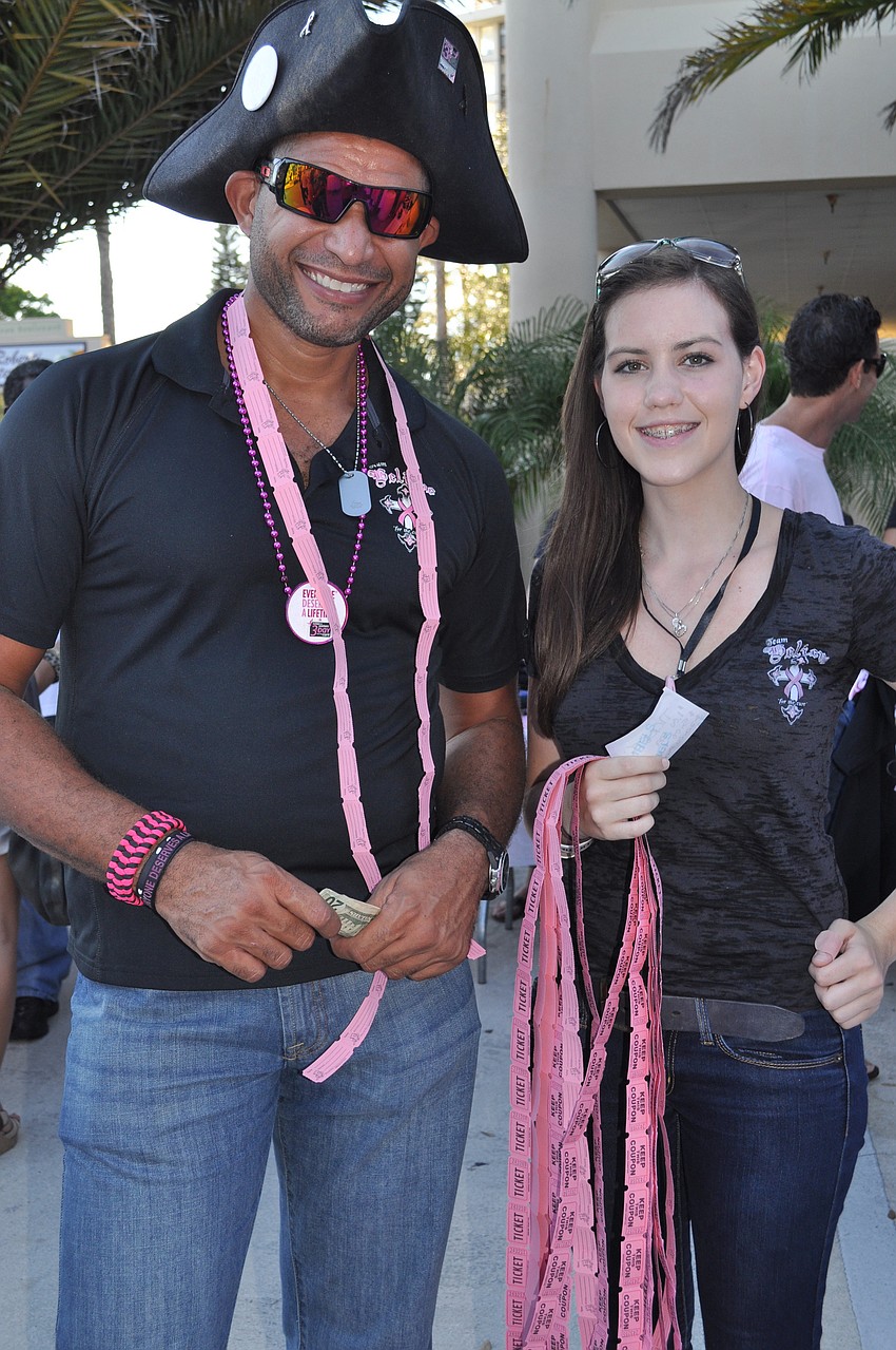 Cesar Rico and Haley Thorne sell raffle tickets at the event.