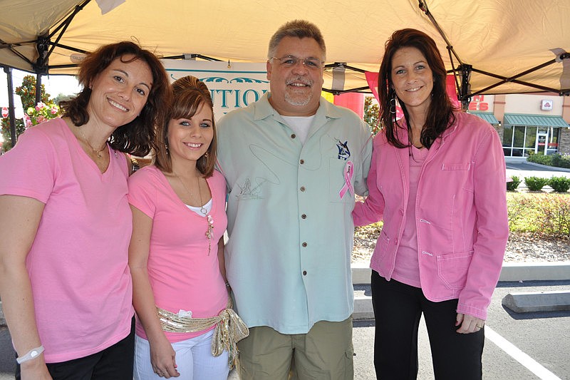 Peggy Workman, Neisha Combs and Mark and Shelly Gutowski, of Boutique Out East Salon and Spa, offered pink hair extensions to guests.