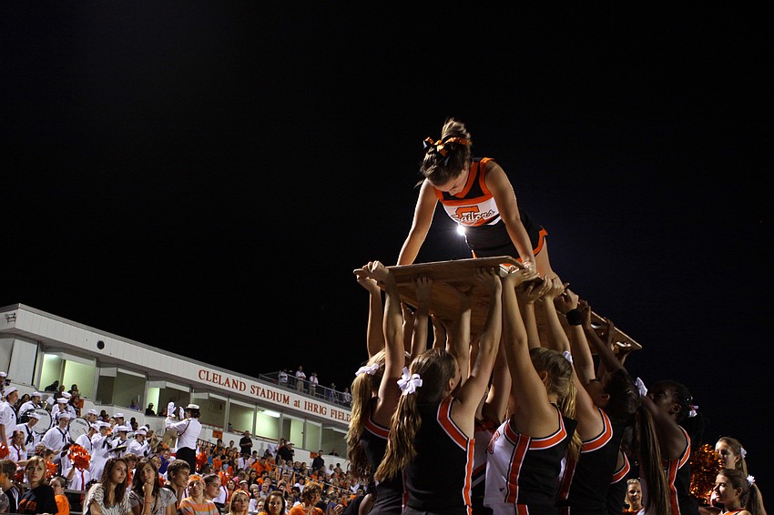 Laney Williams does push ups to count off how many points the Sailors had up on the scoreboard.