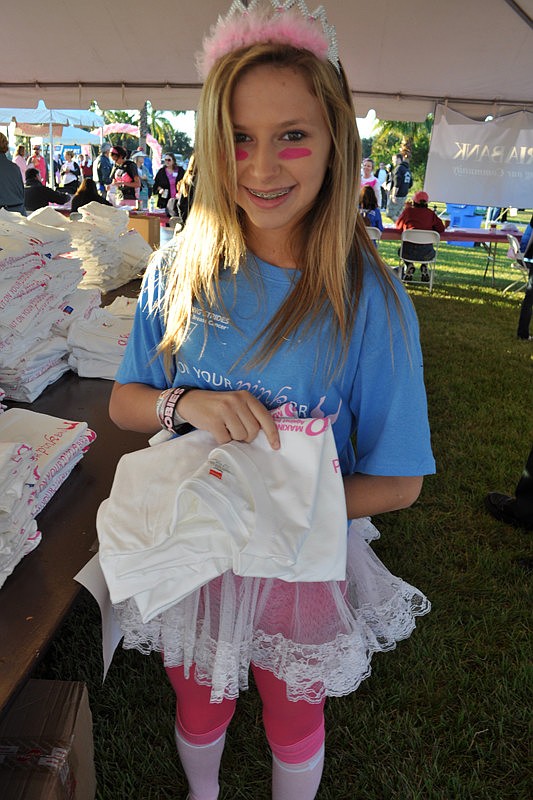 Starla Wilson, 12, passed out T-shirts to participants.