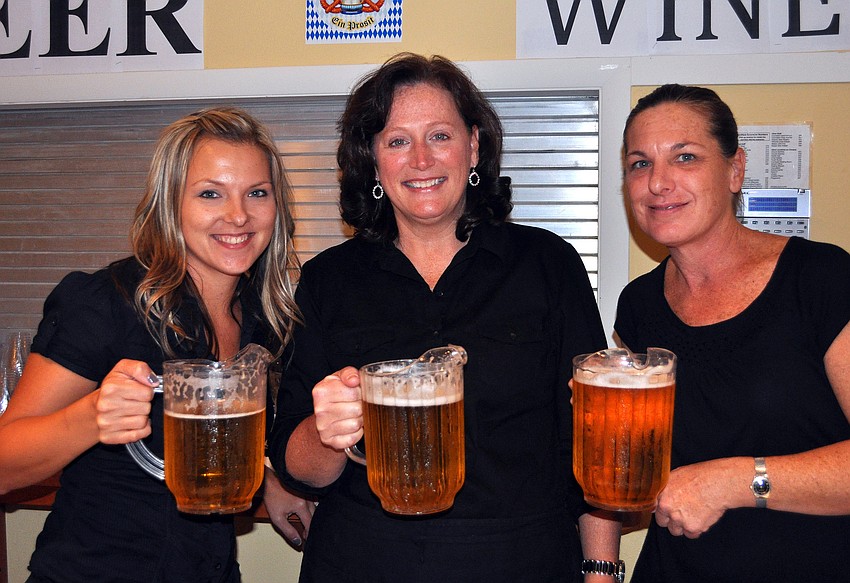 Missy Williams, Marcia Meerman and Jane Holcomb serve up some beer during Oktoberfest Friday, Oct. 21, at St. Boniface's.