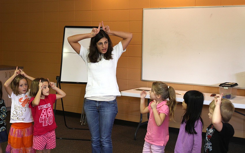 Jennifer Holt from GWiz encourages the preschoolers at St. Boniface to make antennae fingers on top of their heads.