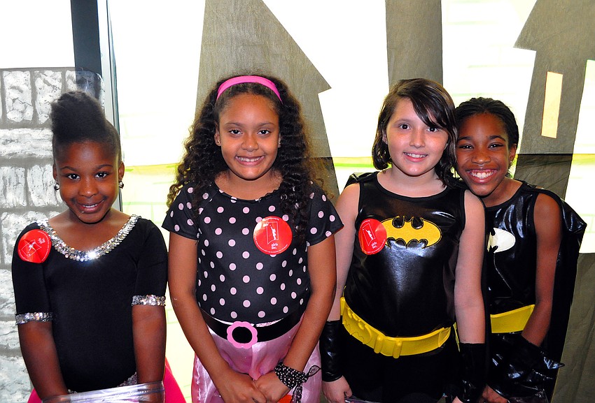 Amiyah Smith and Elaine Jimenez matched in their 50â€™s sock hop outfits while Valentina Monroy and Shamyra Wheeler matched in their Batman costumes, Friday, Oct. 28, during their trick-or-treating event at the Sarasota City Center Office Building.