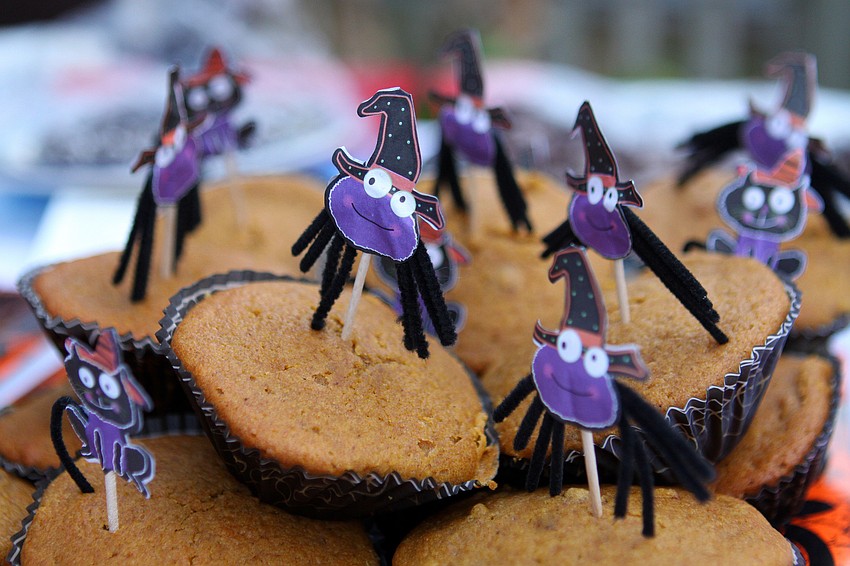 Pumpkin muffins with spider decorations.