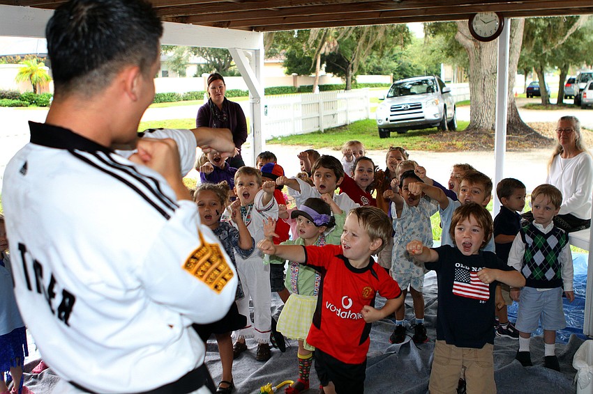 Master Hwang gets the students to do a taekwondo move during their visit to â€œKoreaâ€, Monday, Oct. 31, during International Children's Day at NewGate.