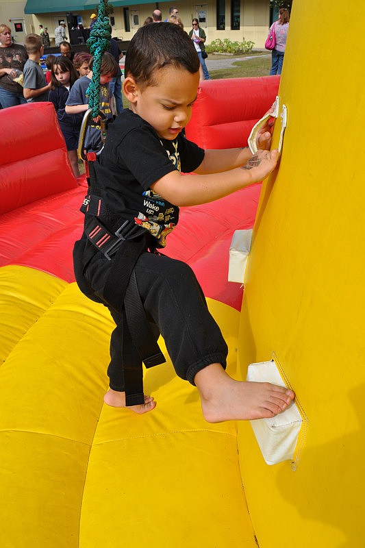Three-year-old Jadyen Shabbazz gave his best effort on the climbing wall.