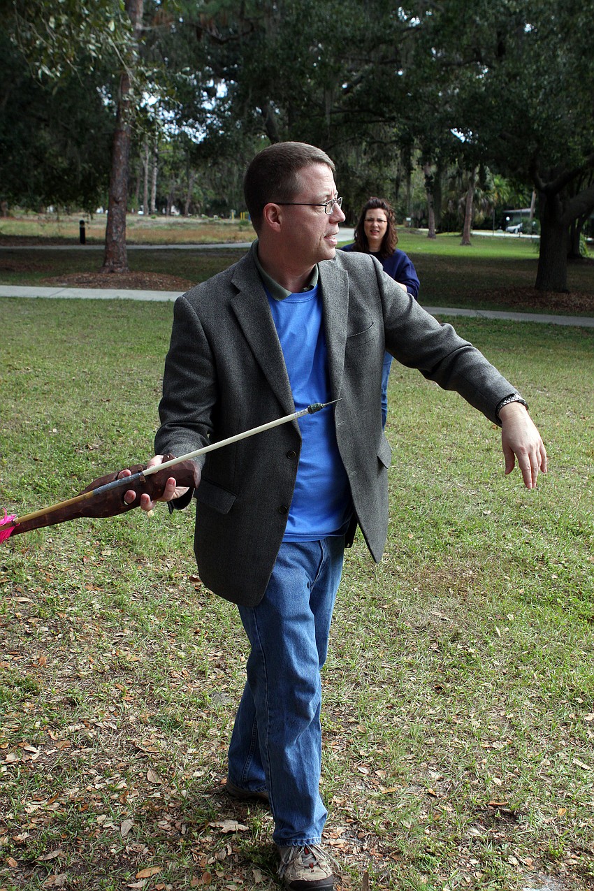 Andrew Jaffee, the Science Lab teacher at Fruitville Elementary, has a go at throwing an arrow using an atlatl, Saturday, Dec. 3, during Fruitville Elementary's junior archaeology day at New College's Public Archaeology Lab.