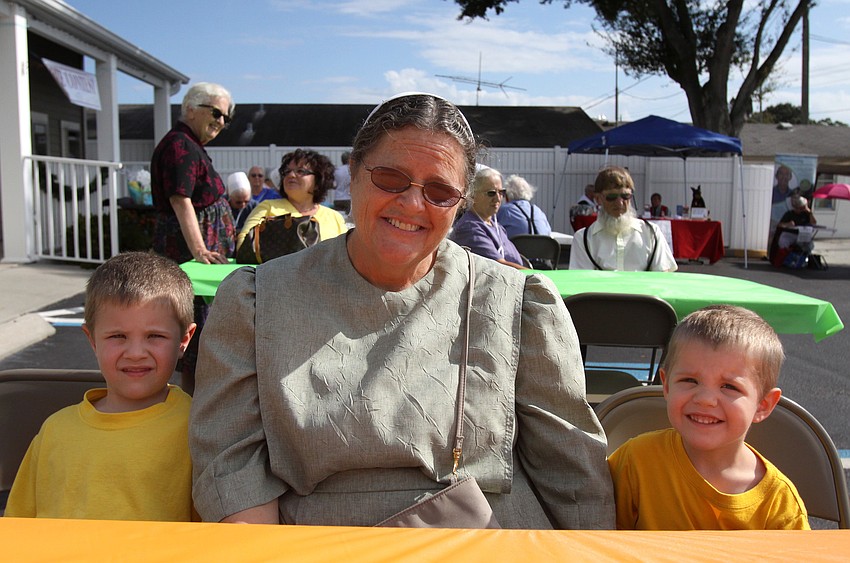 Josh, 4, and Joel, 3, Miller sit with their grandma, Mary Fisher at the 1st annual pie contest, Friday, Dec. 9 at Everence Federal Credit Union.