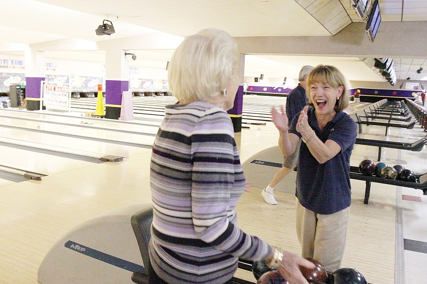 Jane Johnson, right, from Sarasota Yacht Cllub, congratulated Lola Keeler on getting a strike during the clubâ€™s yearly competition with Bird Key Yacht Club in February.