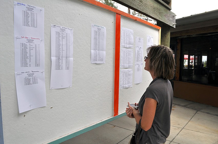 Meredith McGirr looks to see how her son placed in a race Saturday, Sept. 3 during the 65th Labor Day Regatta at the Sarasota Sailing Squadron.