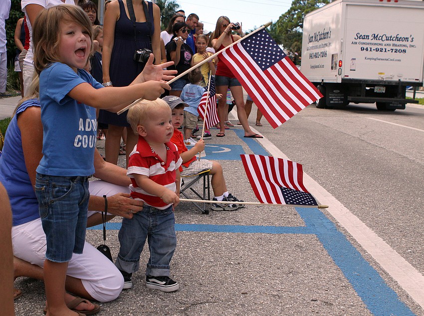 Brittin Sullivan, 4, and Ridge, 1, wait to see their uncle walk by with the rest of the Sarasota County firefighters Sunday, Sept. 11, during the Remembrance March.