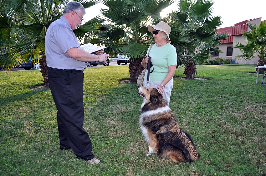 Deacon Tom Grant blesses Julie Brady's dog, Austin, 5.
