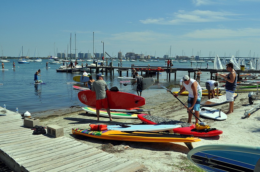 People begin to get the boards back in the water to head out for the poker run Saturday, Oct. 1 during the 3rd annual SUP Fest at the Sarasota Sailing Squadron.