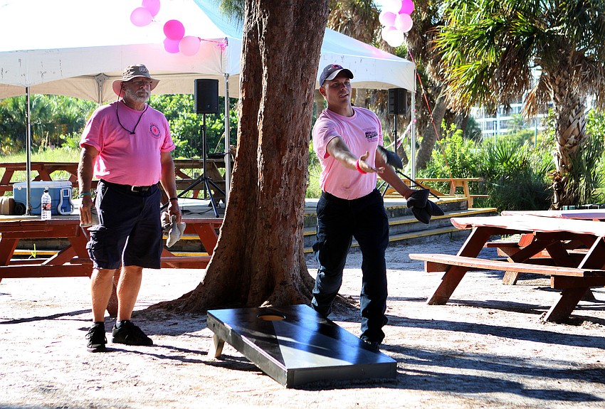 Don Hayworth and Josh Baker play corn hole Tuesday, Oct. 4 out at Siesta Key Beach.