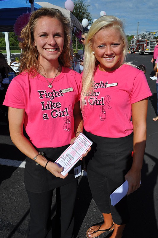 Marina Edwards and Carlie Mazurek, of Crowders, passed out fliers.