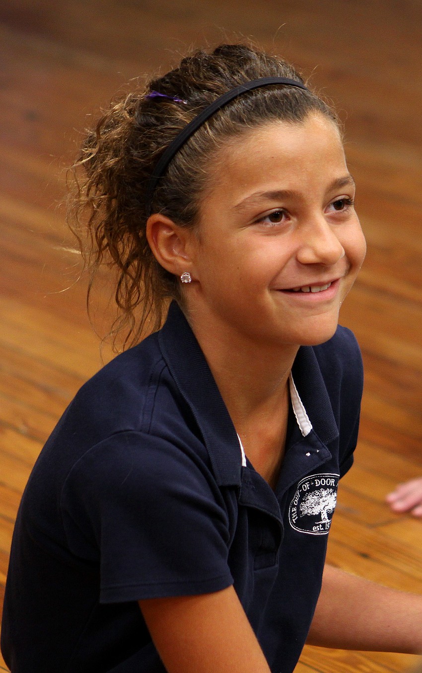 Sydney Sforzo, 10, smiles at Jack Dowd while he talks about the life sized sculpture he made of her grandfather, Dick Vitale.