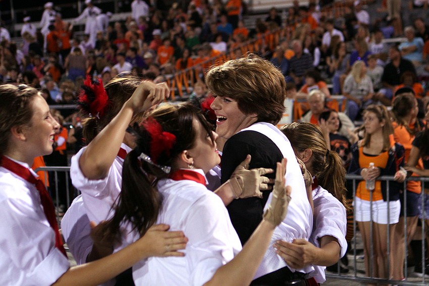 Stephen Wright laughs and smiles as his friends from the band come over to congratulate him on still being on the senior homecoming court.