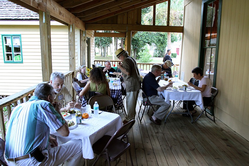 People enjoy eating their Broadway Bar dinner on the back porch of the Bidwell-Wood House.