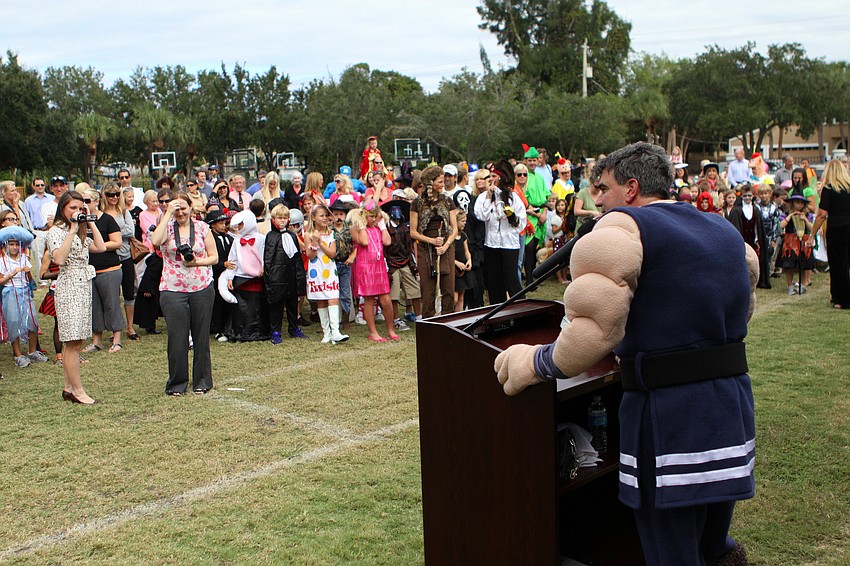 David Mahler, wearing the Thor costume, speaks to the crowd about the new athletic pavilion, Monday, Oct. 31, at Out-of-Door Academy.
