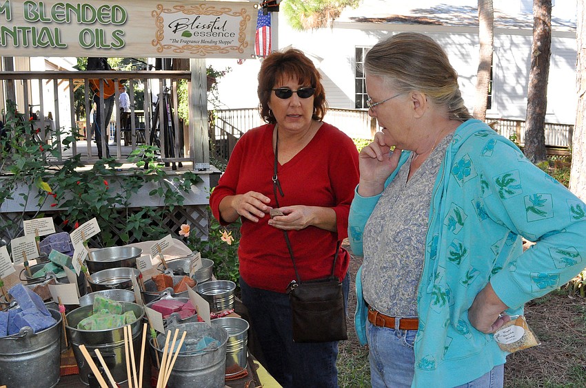 Mary Arndt gives a sample of one of her products from her company, Blissful Essence, to Barbara Caramenico.