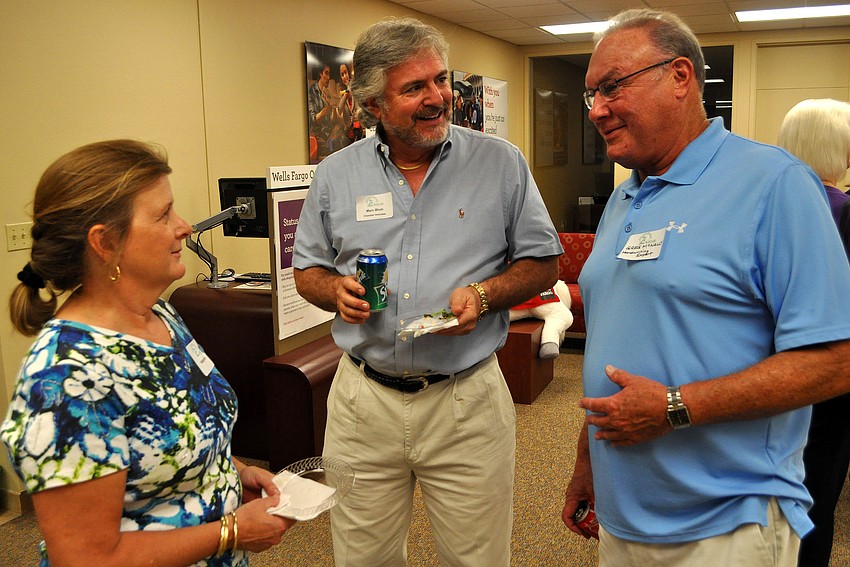 Kathy and Marc Blum chat with Greg McNally at the After Hours and Business Card Exchange, Thursday, Nov. 17, at Wells Fargo Bank.