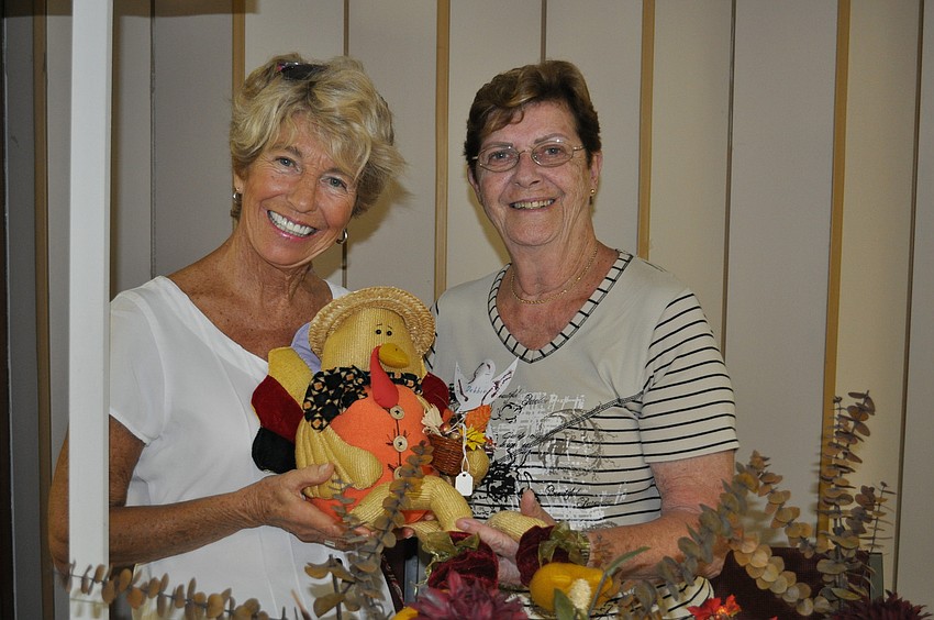 Patty Sabow and Debbie Chalmers sell hand-made table holiday table decorations