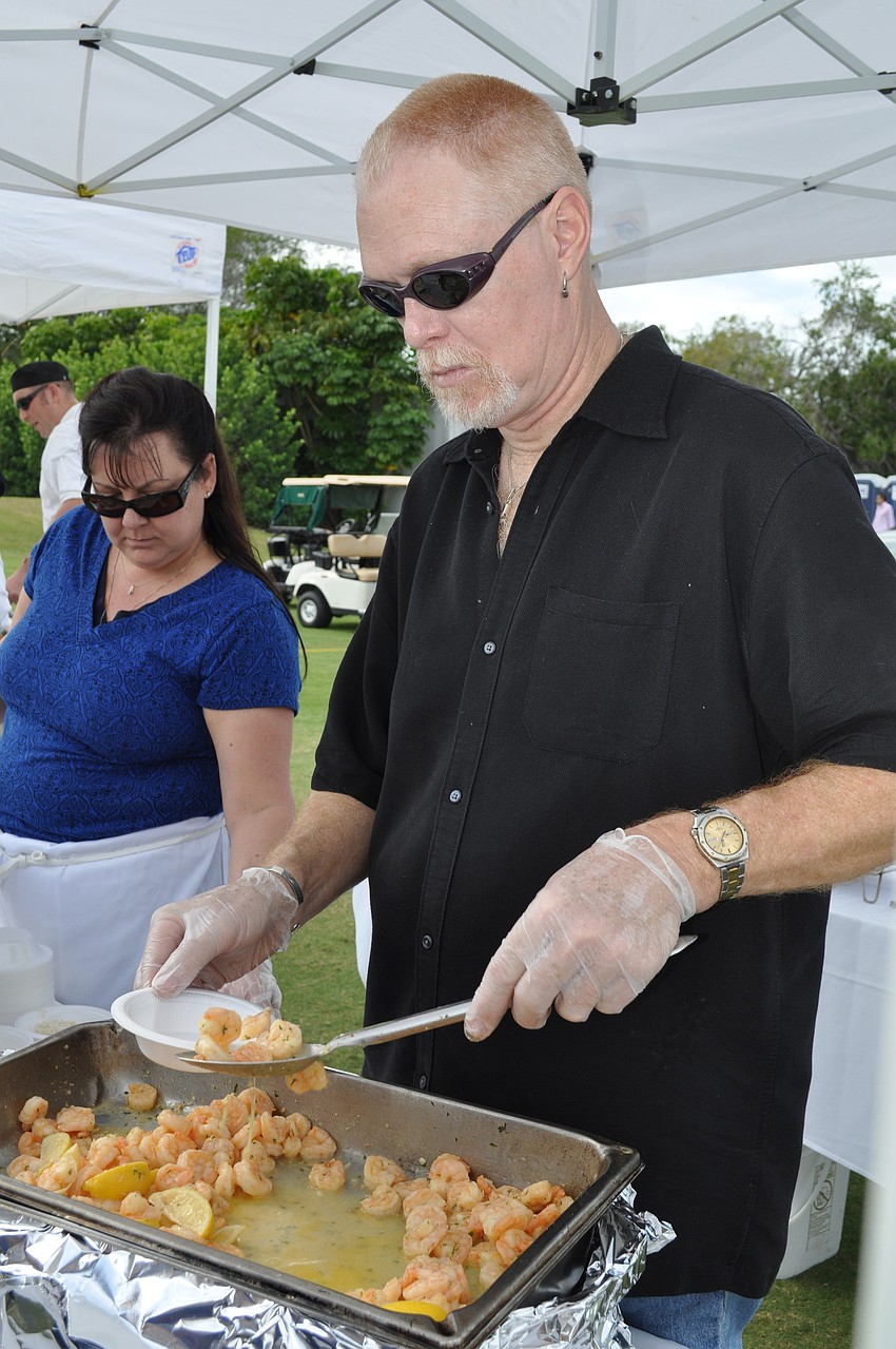 Owner Alan Moore serving shrimp at the Moore's Stone Crab booth