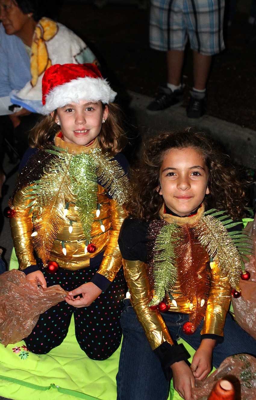 Catherine Parrott, 9, and Emilie Rojas, 9, watched the parade dressed as palm trees.