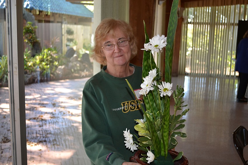 Janet Marchman poses with her arrangement.