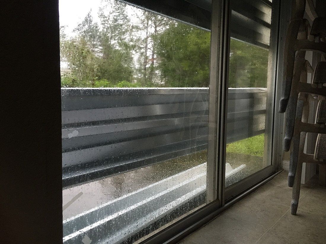 By 10 a.m. Oct. 7, Hurricane Matthew had pulled a couple of shutters from one glass door in an L-Section home a Palm Coast Observer reporter was sheltering in. (Photo by Jonathan Simmons)