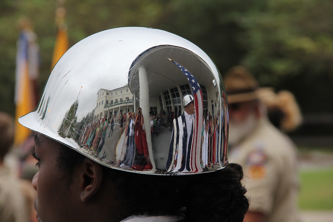 Veterans Day 2015 as seen off the reflection of an ROTC student's helmet. Photo by Jacque Estes