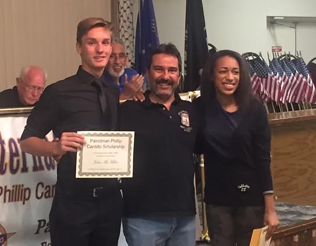 Todd Cardillo, center, presented awards to John McMillan and Brittany Williams on behalf of the Palm Coast FOP. Courtesy photo