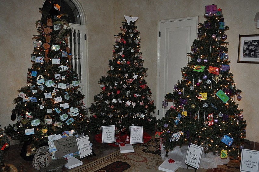 A corner of the room displaying trees created by local schools