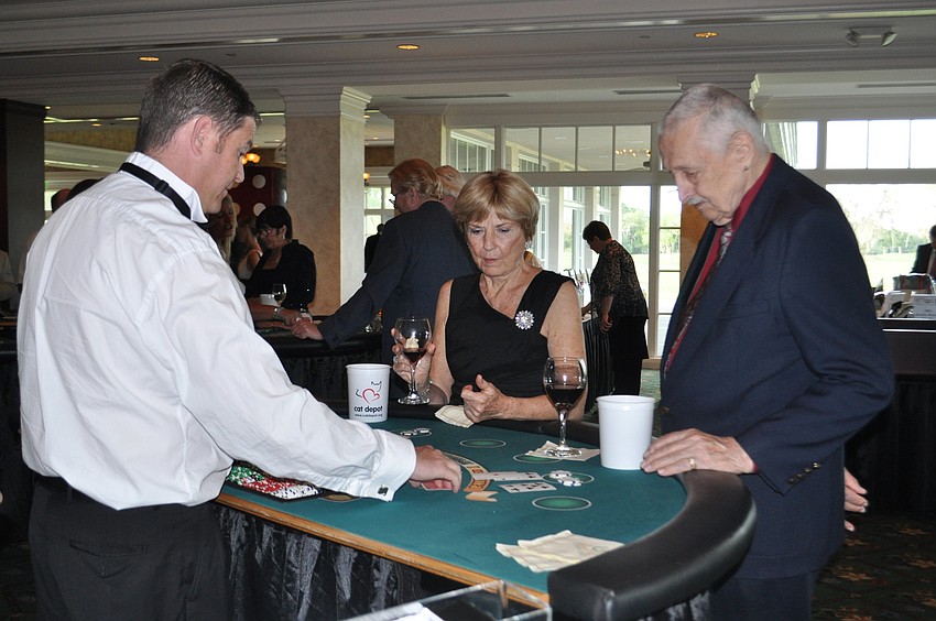 Thomas Mathews dealing to Dawn and Bob Schnuck