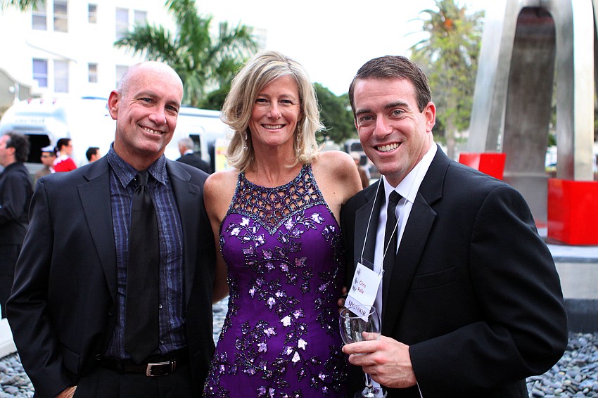 Scott and Laura Spencer pose with Chris Rolle