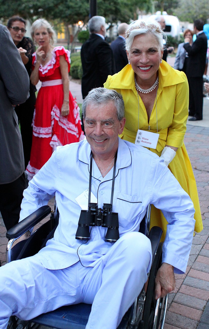 Diane Roskamp pushes Bob Roskamp towards the dinner table.