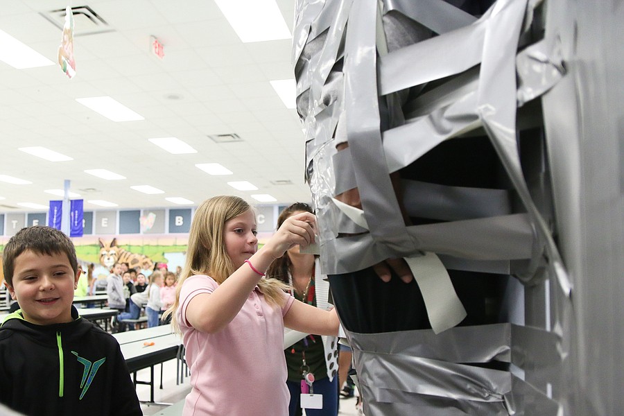 Turrill students tape principal, teachers to wall in fundraiser for new  books - Lapeer Area View