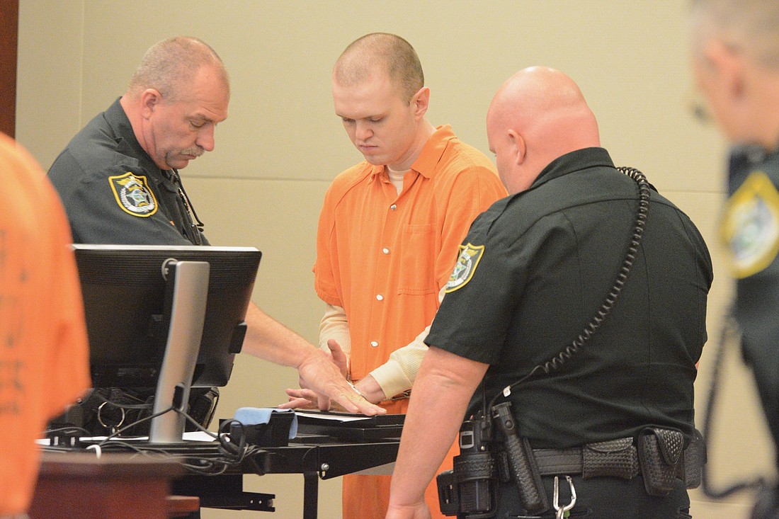 Paul Dykes is fingerprinted after entering a guilty plea during a Feb. 13 court hearing. (Photo by Jonathan Simmons)