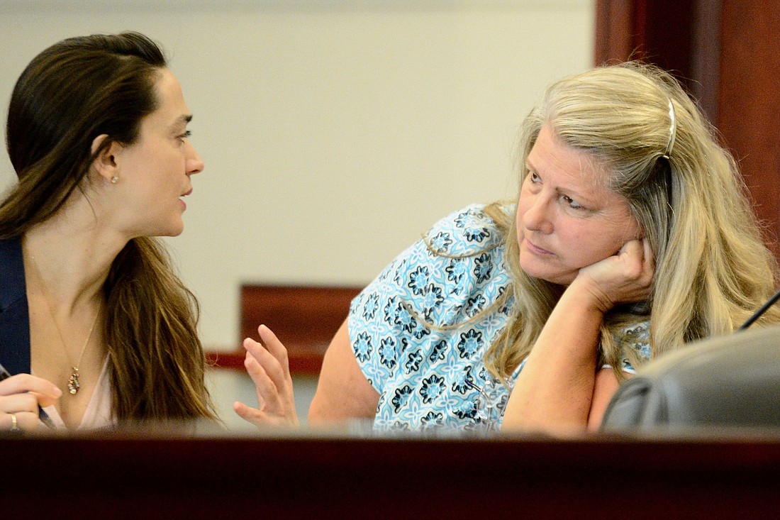 Attorney Ashley Kay speaks with  Kimberle Weeks (Photo by Jonathan Simmons)