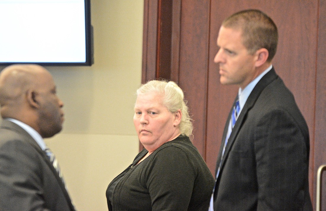 Dorothy Singer, center, with defense attorneys Junior Barrett, left, and Kevin Carlisle  (Photo by Jonathan Simmons)