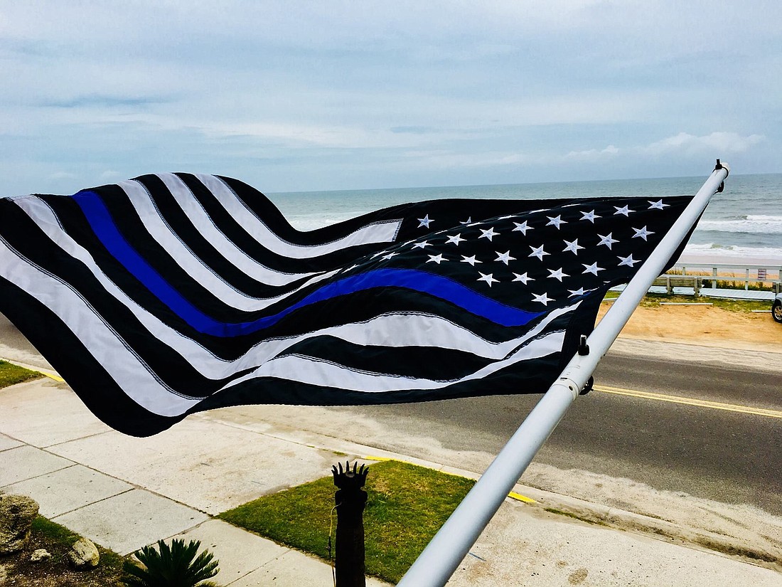Arthur Woosley provided "thin blue line" flags up and down A1A and Moody Boulevard. Courtesy photo by Matt Dougney