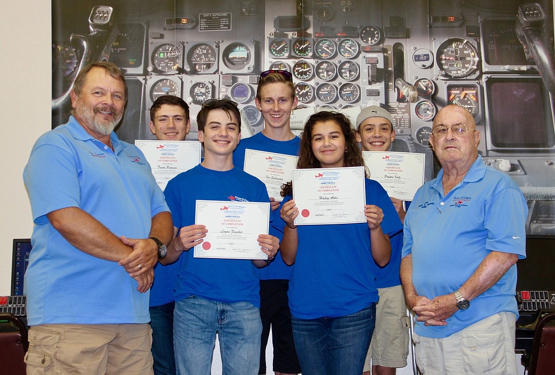 The students receiver their certificate of completion of Teens-In-Flight's first summer camp. Photo by Ray Boone
