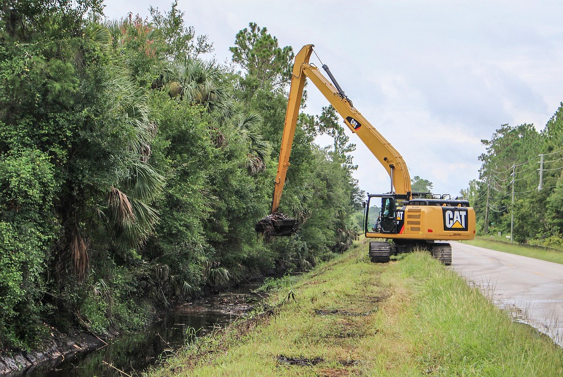 Clearing the canal along County Road 305. (Photo courtesy of the Flagler County government)