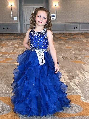 Palm Coast resident Emma Minn, 6, loved picking out her blue dress ' one of her favorite colors. Photo courtesy of Kara Minn