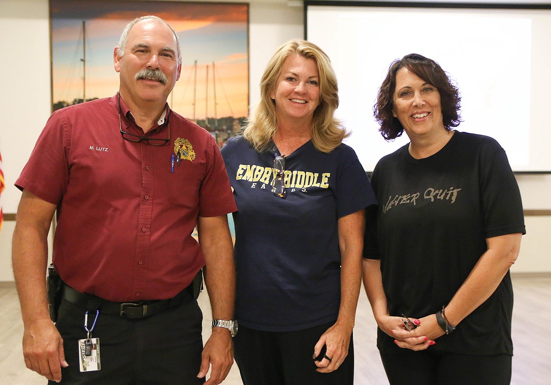 FCSO Sgt. Michael Lutz stands with two of the class participants, School Board member Colleen Conklin and Andrea Sweeney, of Flagler Schools Food Services. Photo by Paige Wilson