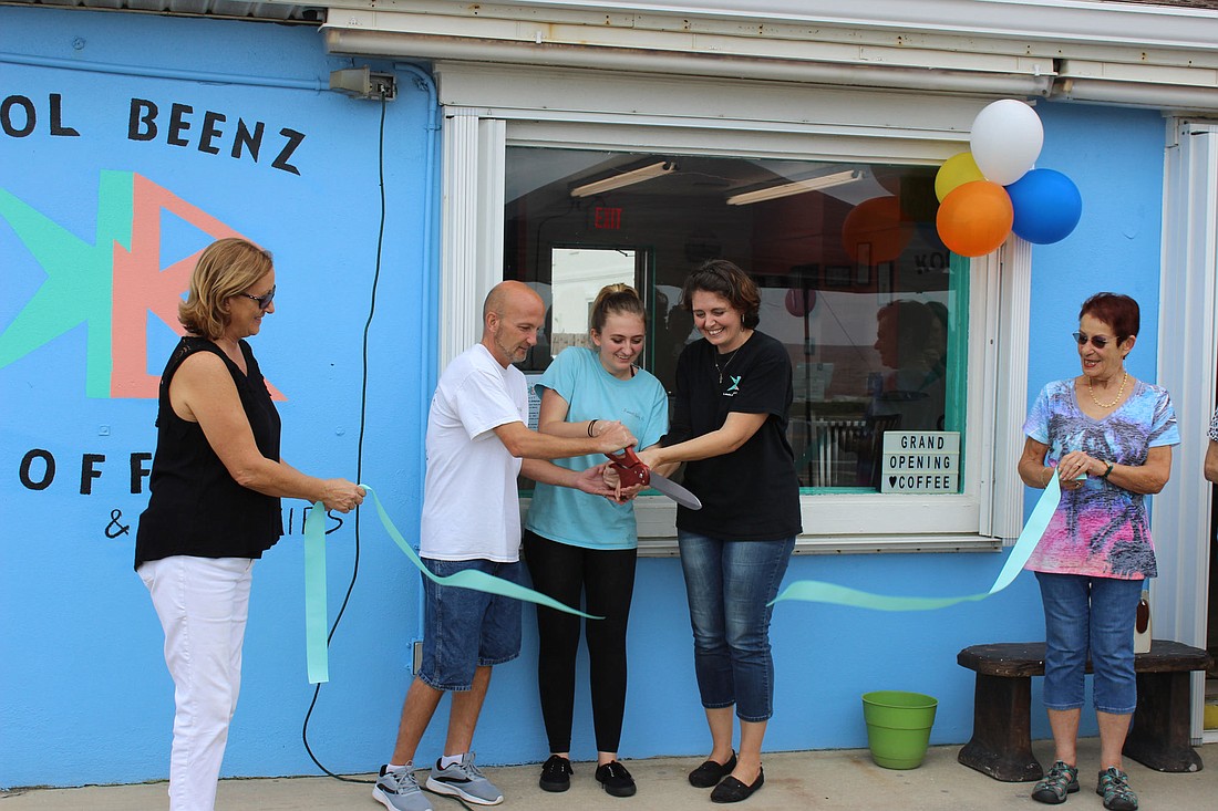 Kool Beenz owners Tim and Jody Bulischeck, with daughter Kyra, cut the ribbon at the shop's grand opening in Flagler Beach. Mayor Linda Provencher (left) and Commissioner Jane Mealy officiated. Courtesy photo