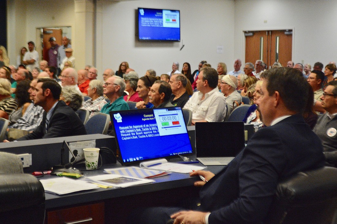 Residents packed the commission chambers for the meeting. County Administrator Craig Coffey is at right.  (Photo by Jonathan Simmons)