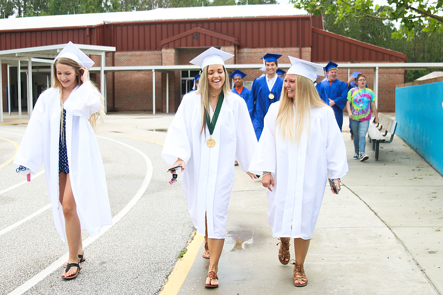 MHS senior Madison Morrow and FPC seniors Kaleigh Freshcorn and Shelby Tatum get ready to walk through another hallway at OKES in May. Photo by Paige Wilson