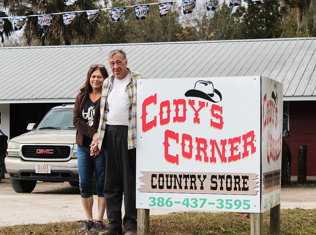 Ed and Linda Corcoran in front of Cody's Corner, which had a grand opening on Feb. 1. Photo by Ray Boone